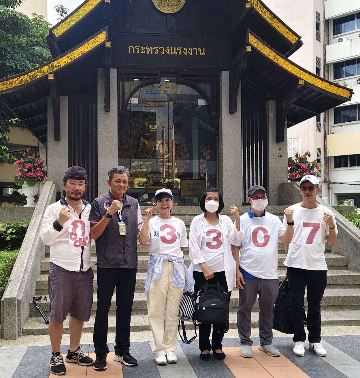 Dr. Boon and Khor Khuen movement members in front of Ministry of Labour with protest flags